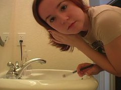 7X3.net presents: Redhead in tee shirt does her makeup
