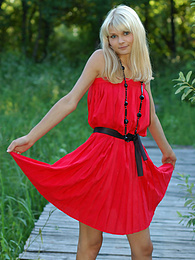 7X3.net presents: Naughty teen appears in her sexy red dress and starts removing it passionately and moving slowly.